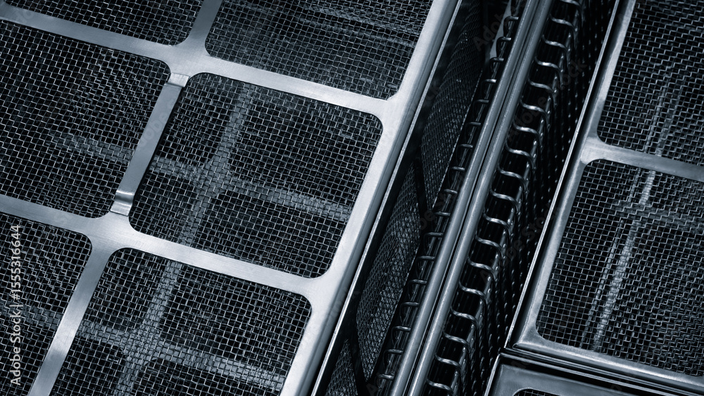 Poster close up of dark blue and silver mesh with squares. The mesh is made of metal and has a grid pattern
