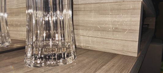 Close up of a glass jar on top of a wooden shelf