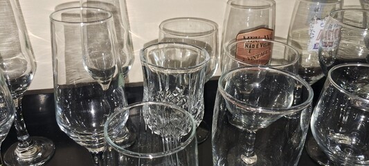 Glasses of wine, champagne and whiskey on a dark wooden counter