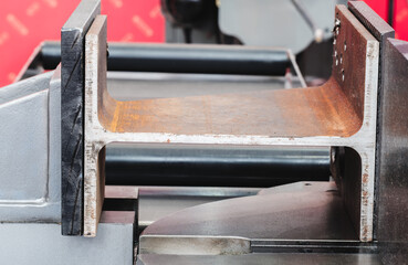 Metal part held in place by sawing machine, industrial concept background