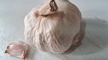 Garlic bulb and clove on a cutting board