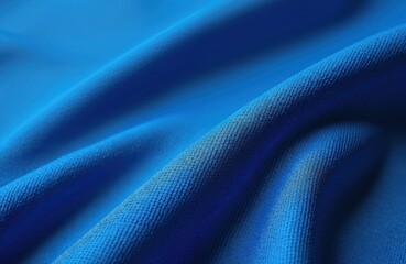 Naklejka premium Close-up of blue sport jersey fabric texture. Breathable synthetic material, suitable for football, basketball, volleyball, hockey, rugby, lacrosse, handball. Ideal design for sportswear, t-shirts,