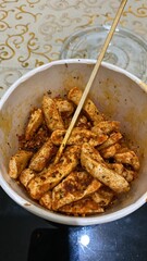 fried meatballs with spicy seasoning in a cup