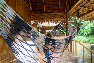 Vacation in Thailand in bugalow. Sea, beach, tropical fruits and drinks. Fit couple in hammock.