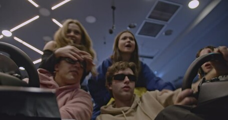 Friends enjoy driving simulators together, experiencing the thrill of racing and cheering each other on in a friendly competition.