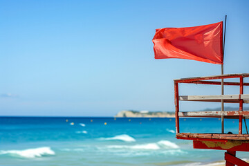 Red Flag Raised by Lifeguards Means No Swimming Allowed Due to Rough Seas and Dangerous Conditions for Tourists