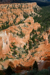 View from canyon rim of rock hoodoos and the queens loop hiking trail, summer vacation exploring in Bryce Canyon National Park, Utah
