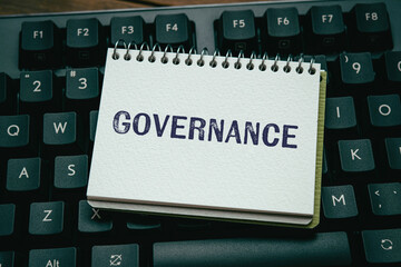 There is notebook with the word Governance. It is as an eye-catching image.