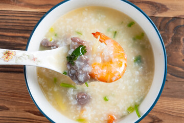 top view fresh shrimps and beef porridge at horizontal composition