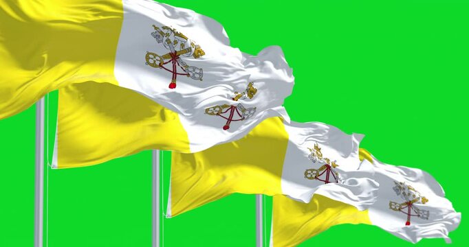 Flags of Vatican City waving in the wind isolated on green background