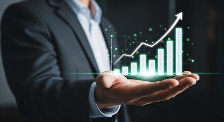 Man holding a glowing financial bar chart with an upward trend line. Concept of business growth, success, and investment projection.