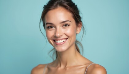 Portrait of young woman with gentle smile on pastel blue background. Beauty, elegance, healthy skin, happiness, positivity, self-care. Perfect for cosmetic, beauty, wellness, spa, skincare projects.