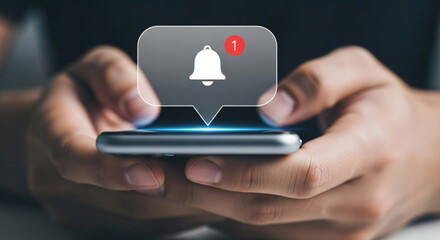 Man holding a smartphone with new notification and a bell icon. Social media message concept for digital communication and mobile technology.