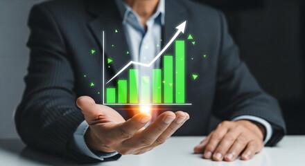 Man holding a glowing hand with a green bar and line chart. Financial growth concept for business investment and success.