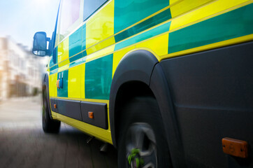Ambulance - emergency services ambulance vehicles travelling to scene. The medically equipped transport rushed patients with paramedics to a health care facility, such as a hospital, for treatment.