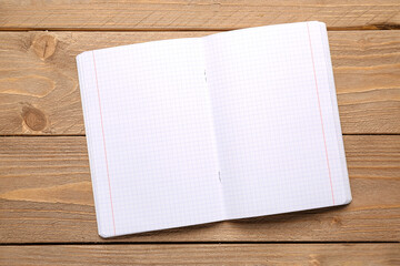 Blank copybook pages on wooden background