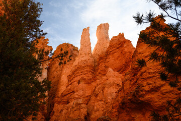 Looking up at dramatic twin orange rock hoodoos, summer vacation exploring in Bryce Canyon National Park, Utah
