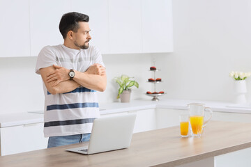 Young man having panic attack in kitchen