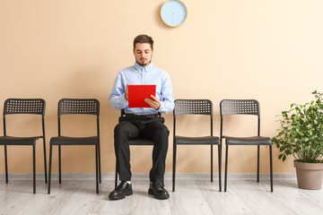 Young man waiting for job interview in office