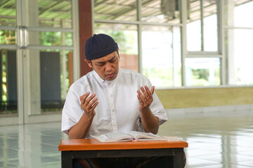 Asian moslem man show praying at mosque show faith believe to god. Religion, islamic photo concept