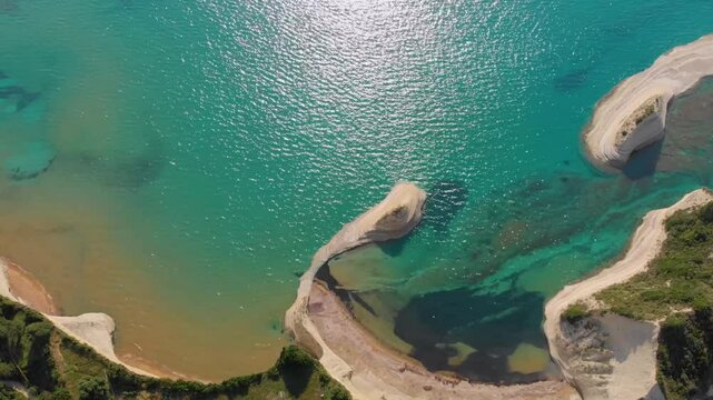 An breathtaking aerial drone shot captures the stunning natural beauty of Cape Drastis on Corfu Island, Greece.