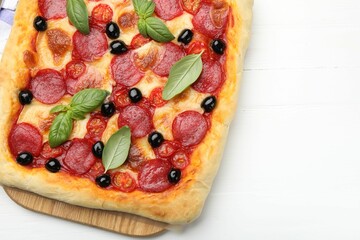 Tasty homemade pizza on white wooden table, top view