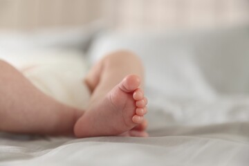 Cute newborn baby lying on bed, closeup. Space for text