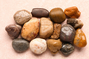 Many pebble stones on pink background