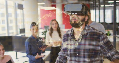 Demonstrating man wearing VR headset interacting with holographic world map in office, with tablet