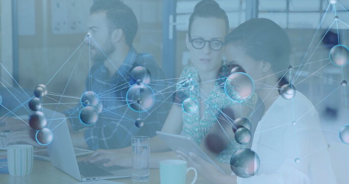 Collaborating three coworkers at office meeting area, with laptop tablet molecular network overlay