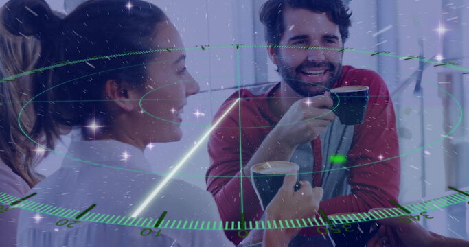 Chatting colleagues holding ceramic coffee mugs in office lounge, with holographic interface