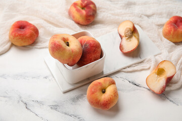 Bowl with sweet fig peaches on white background