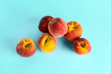 Sweet peaches on blue background