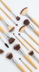 An arrangement of various cosmetic applicators on a clean, light background