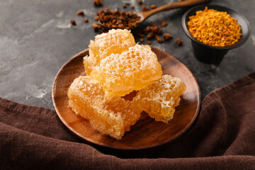 Plate with sweet honeycombs on black background