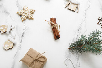 Christmas tree branches with gift box and cinnamon on white background