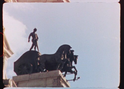 Vintage toned quadriga sculpture adorning Cibeles Fountain facade, Bank of Spain landmark, Madrid cityscape against azure sky with billowing clouds, captured on analog 8mm film