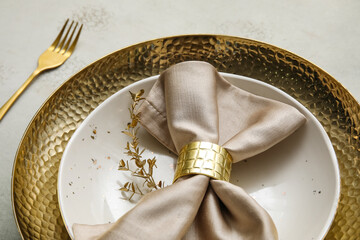 Elegant table setting with golden leaves and fork on grey table, closeup