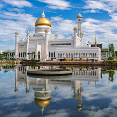 Majestic and ornate, Omar Ali Saifuddien Mosque reflects in the tranquil waters of Bandar Seri Begawan, the capital of Brunei. Its golden dome and intricate details offer a breathtaking panoramic view