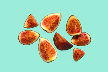 Pieces of fresh ripe figs on turquoise background