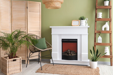 Interior of room with modern fireplace and houseplants