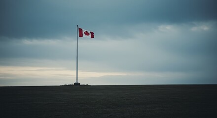 Fototapeta premium Canadian Flag Flying Solo Under a Cloudy Sky