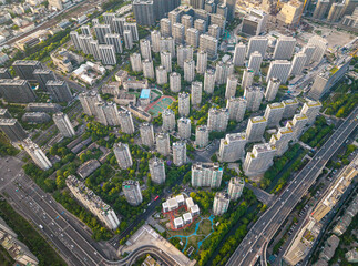 Aerial view of a densely populated residential neighborhood featuring modern buildings surrounded...