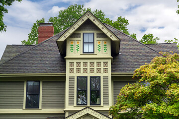 Well-Maintained bushes and wooden picket fence frame a charming neighborhood scene in Rockport, Massachusetts, USA

