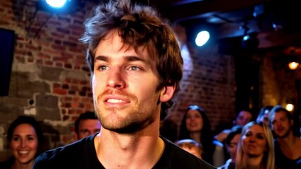A charismatic performer, dressed in a black shirt, is seen smiling broadly and engaging with a lively audience