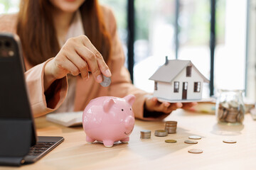 Portrait happy smiling beautiful young asian woman sitting at desk with money and calculator at...