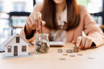 Hand plans home refinance. Pressing calculators, House model, buy or rent, calculators on desk....