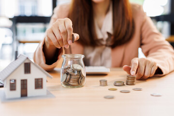 Hand plans home refinance. Pressing calculators, House model, buy or rent, calculators on desk....