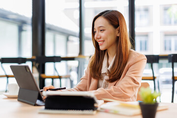 Young busy professional asian business woman company executive or entrepreneur using digital tablet...