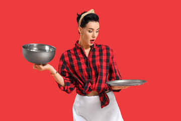Shocked pin-up waitress with cloche on red background